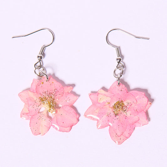 Boucles d'oreilles en fleurs naturelles séchées, fleurs de cerisier roses du japon en résine artisanales
